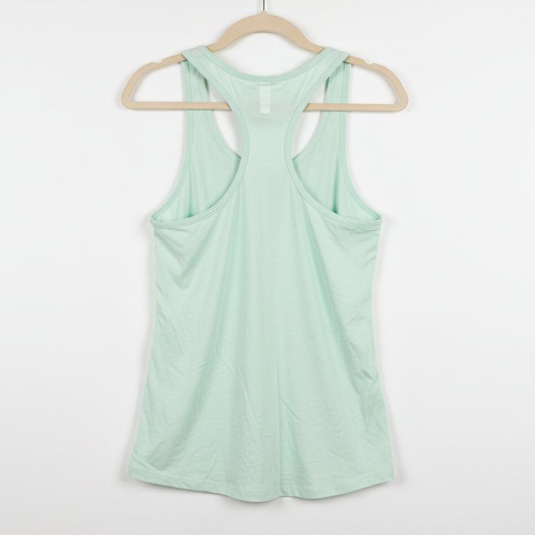 Light green tank top on a textured brown background