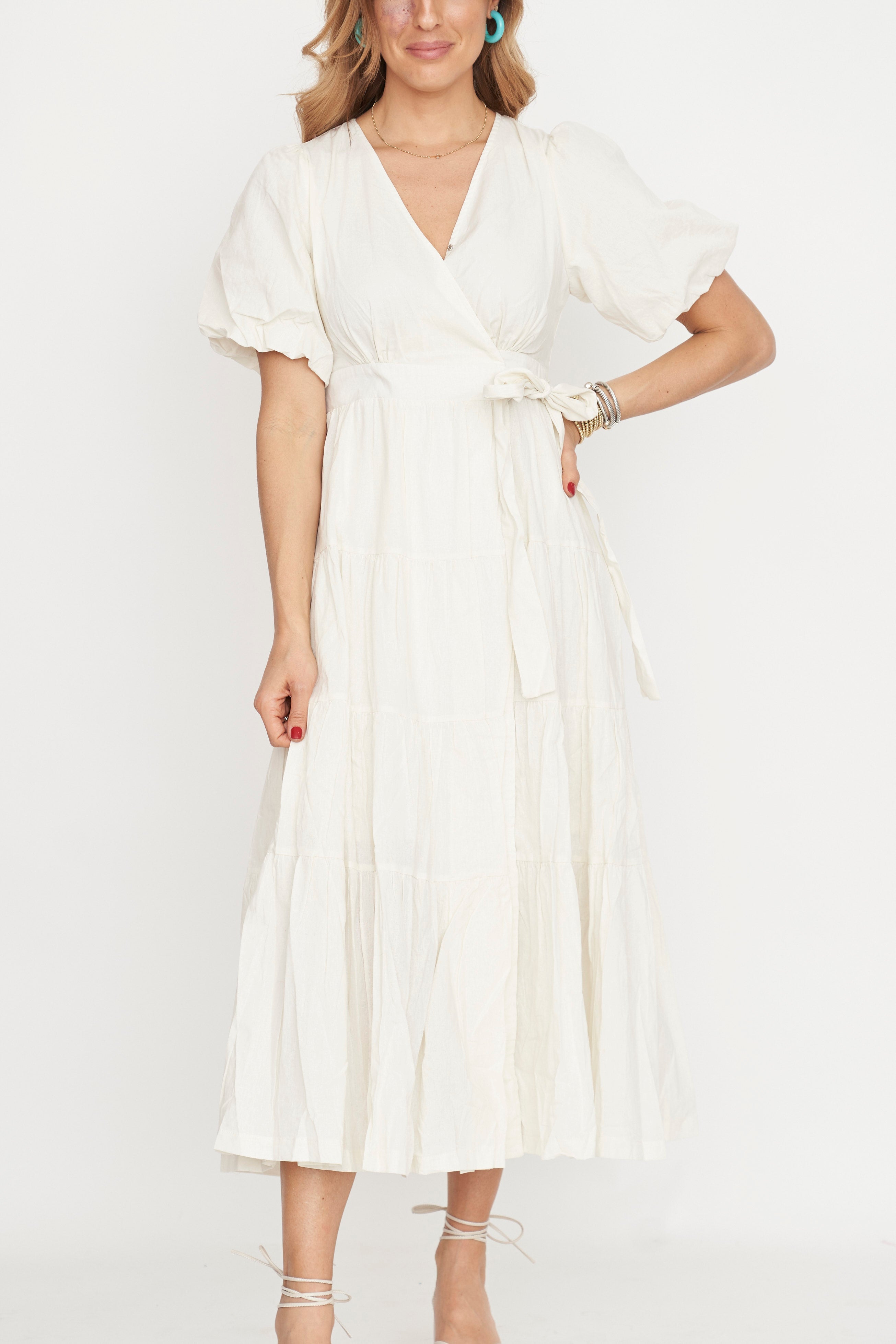 Woman wearing a white dress against a plain background