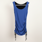 Purple reversible dress on a hanger against a white wall.