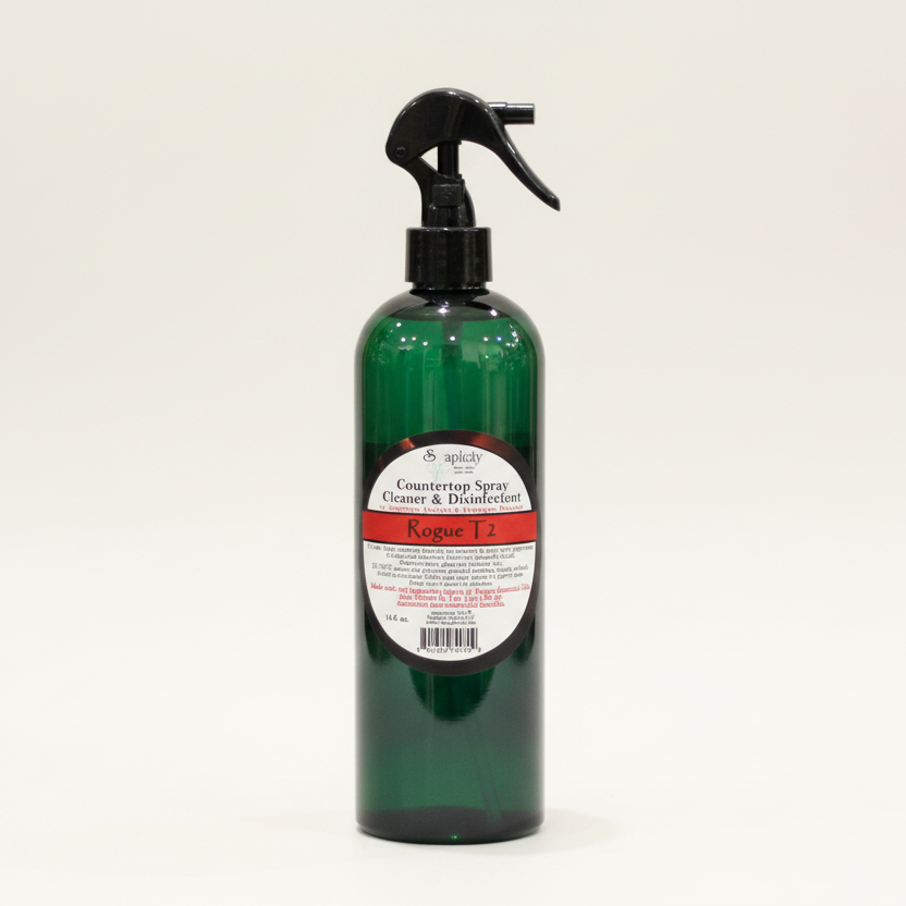 Green spray bottle with a label on a wooden surface