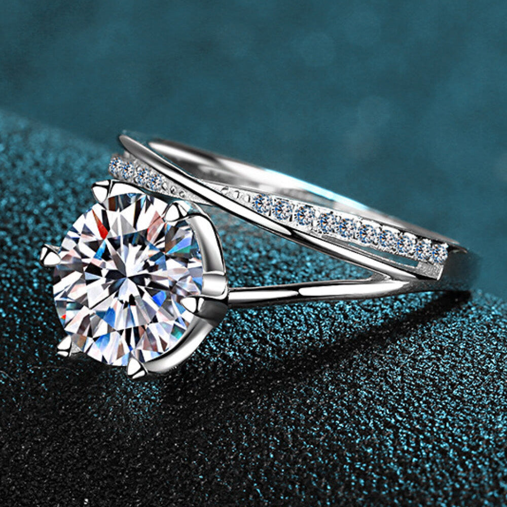 Silver ring with a large diamond on a textured blue background