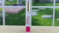 Lip gloss with a blurred outdoor background