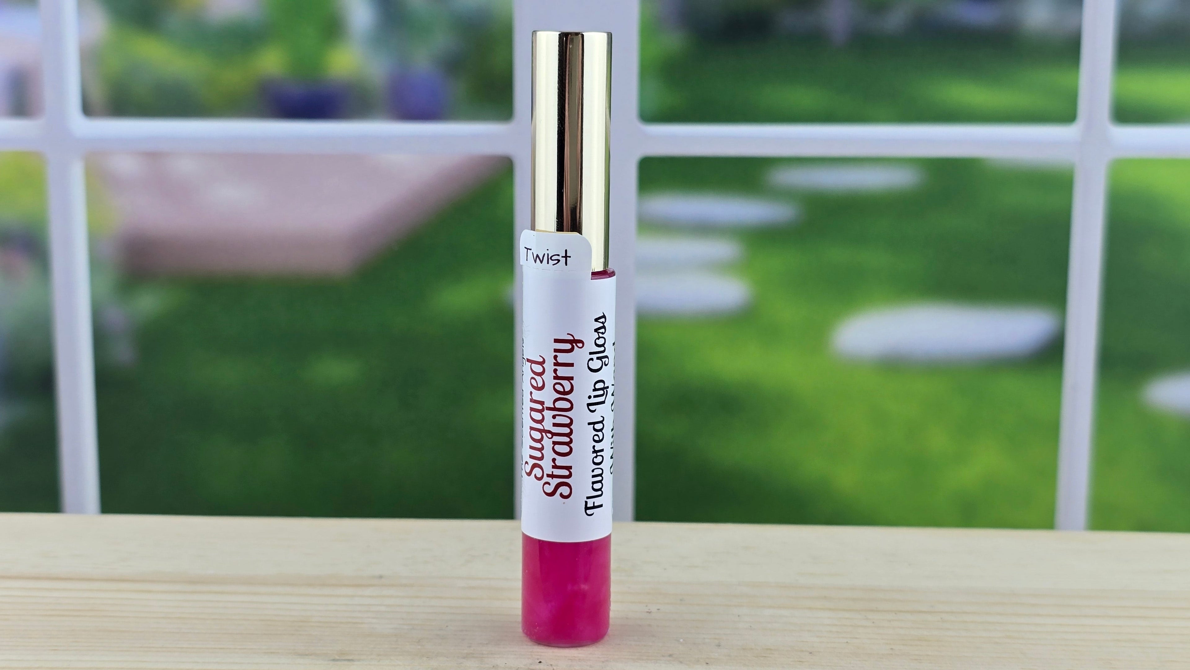 Lip gloss with a blurred outdoor background