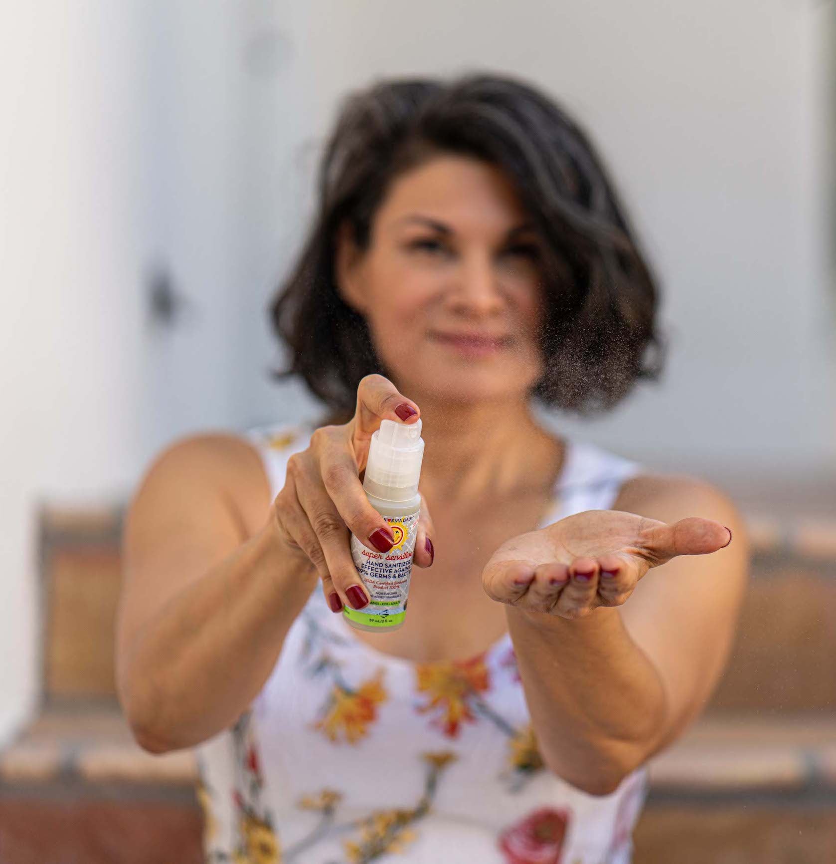 Woman demonstrating a bottle of powder with a blurred background