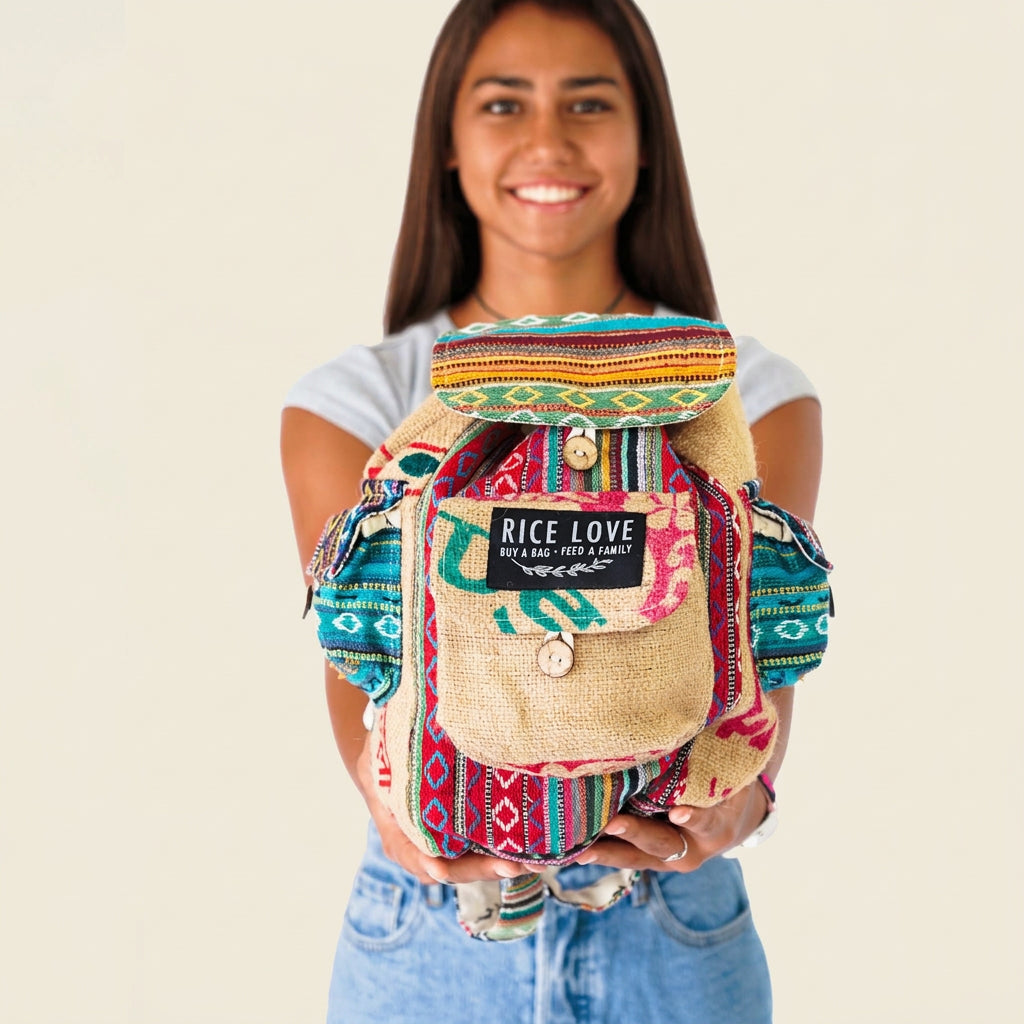Person holding a colorful backpack with 'Rice Love' branding on a white background