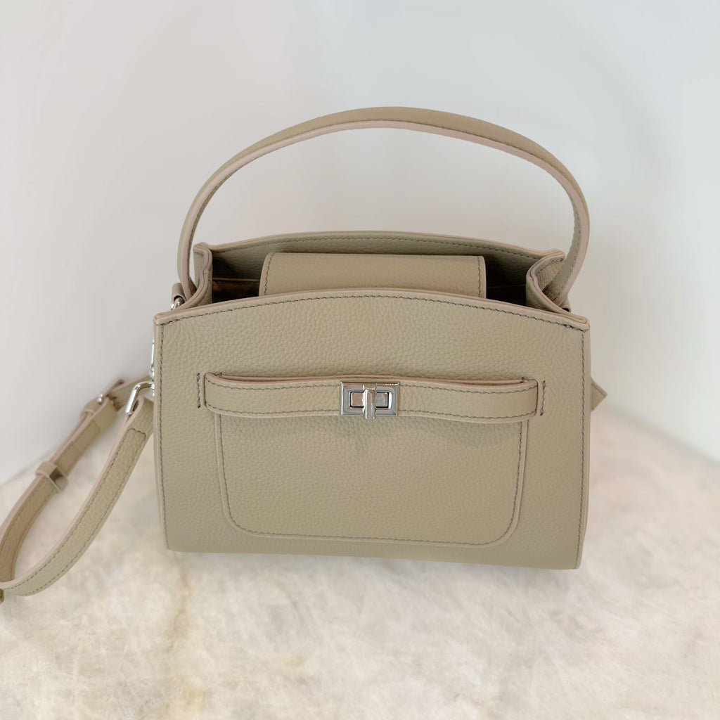 Beige handbag with a strap on a light background