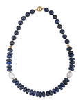 Necklace with blue beads and pearls on a white background