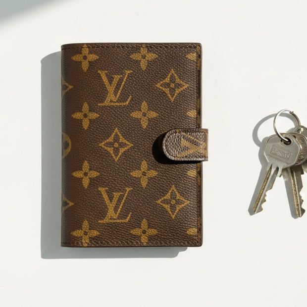 Louis Vuitton monogrammed wallet with keys on a white background
