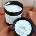 Vanilla Buttercream luxury lotion in black containers on a brown fabric background