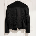 Black jacket hanging on a white door