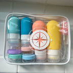 Set of colorful bottles with different colored lids in a clear container on a tiled wall background.