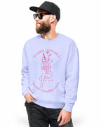 Man wearing a light blue sweatshirt with a graphic design outdoors.