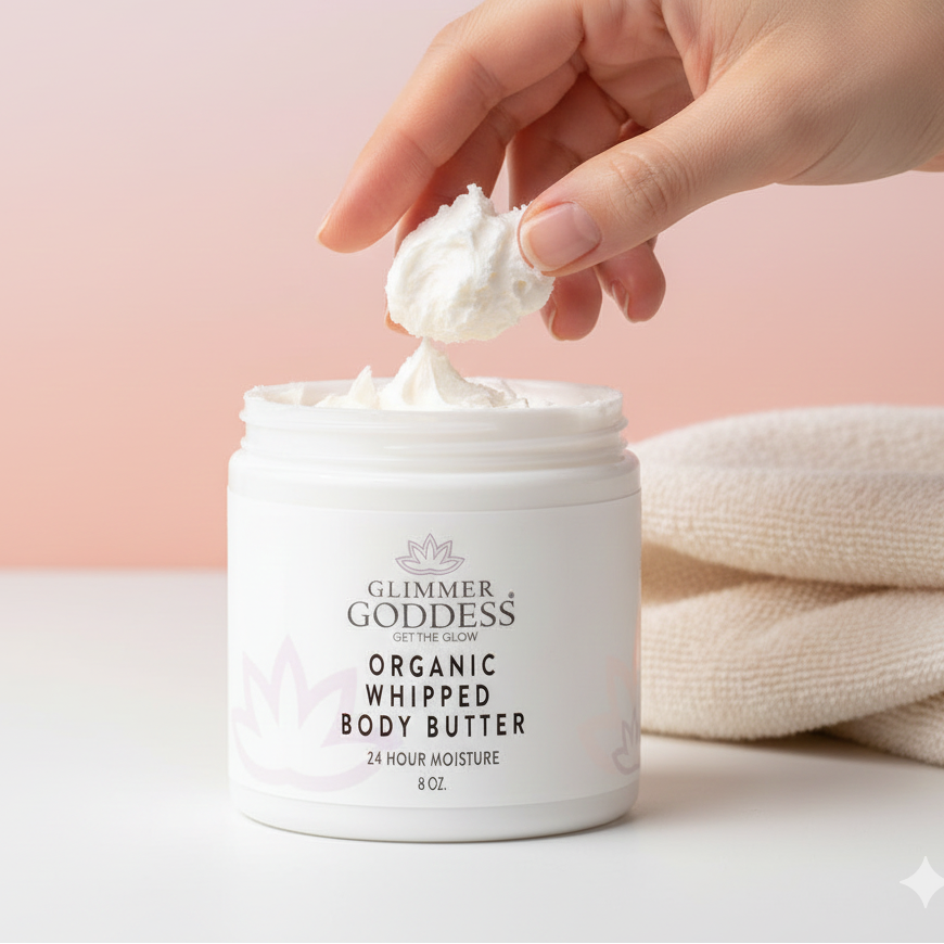Glimmer Goddess Organic Whipped Body Butter with a hand scooping out some of the product.