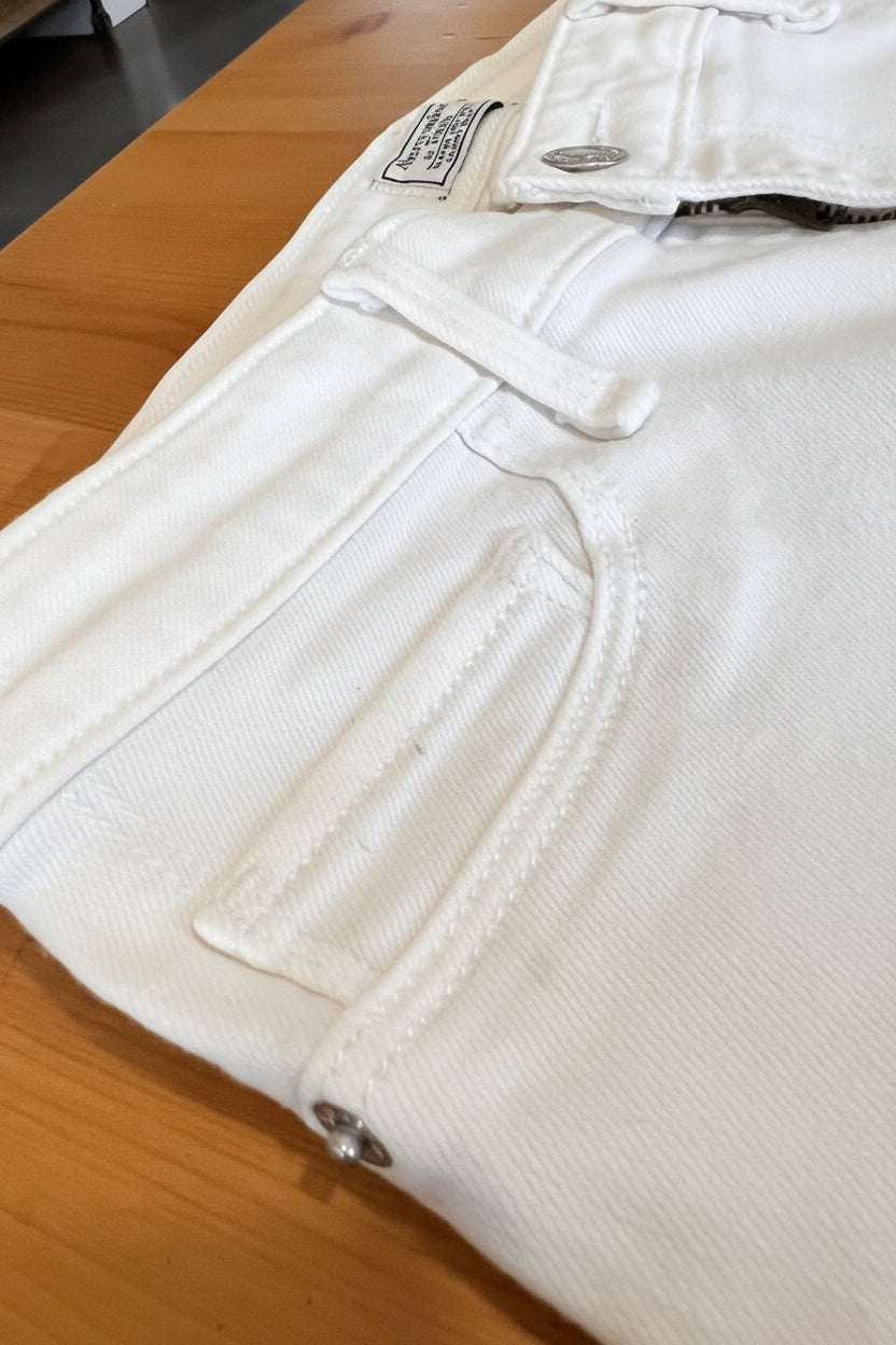 Close-up of beige pants on a wooden floor