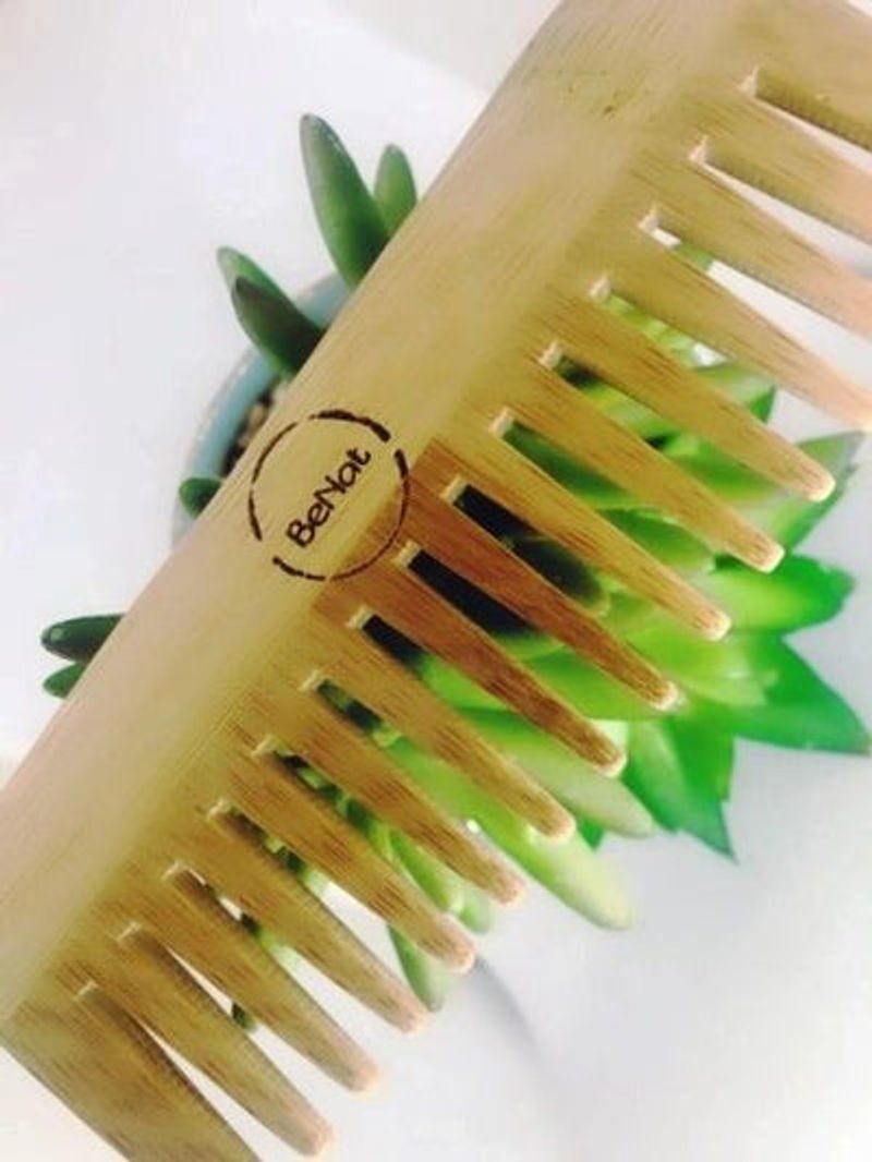 Bamboo comb with a brand logo on a white background