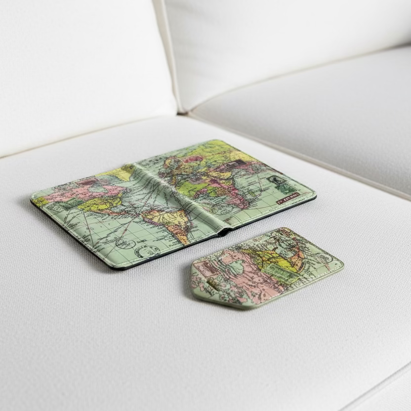 World map passport holder and luggage tag on a textured surface