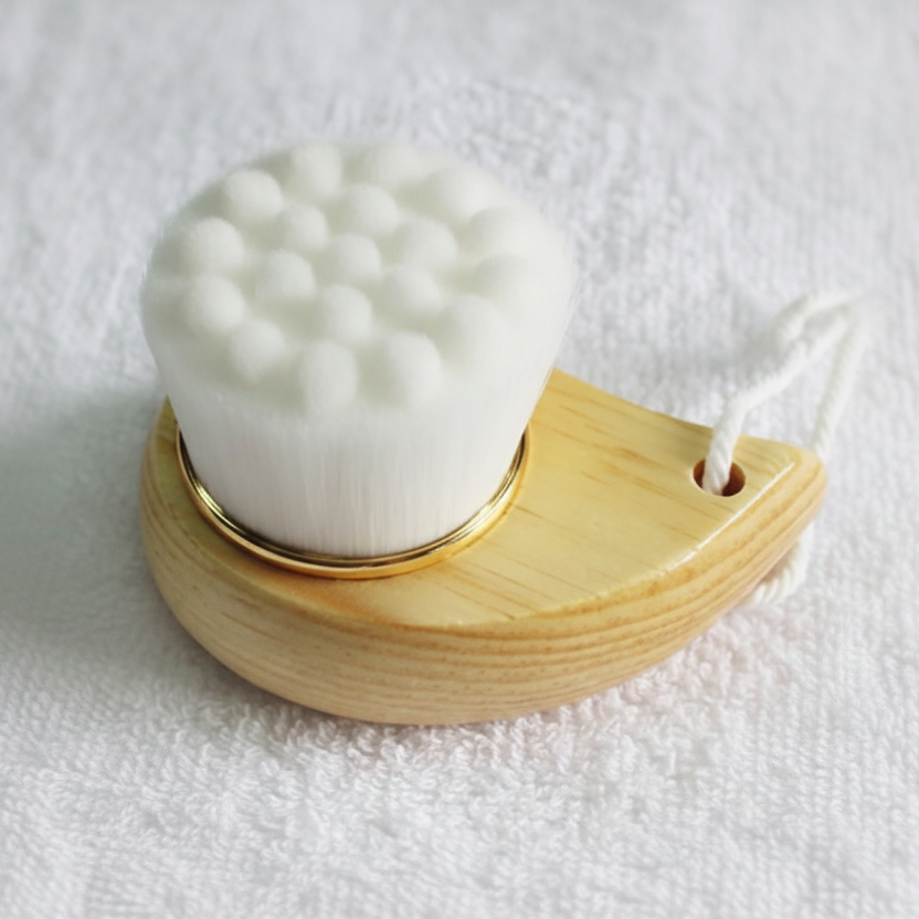 bamboo facial scrubber with wooden handle on a white background