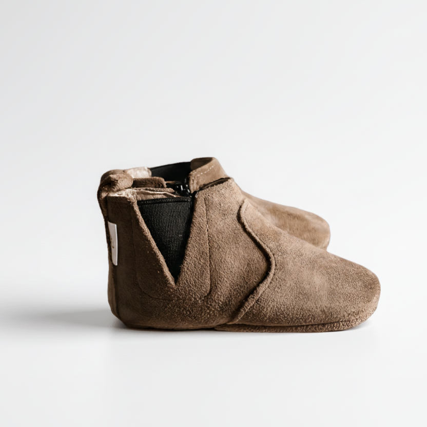 Brown baby bootie on a white background with a sale label.