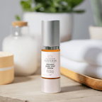 Glimmer Goddess organic dark spot serum on a wooden surface with a blurred background
