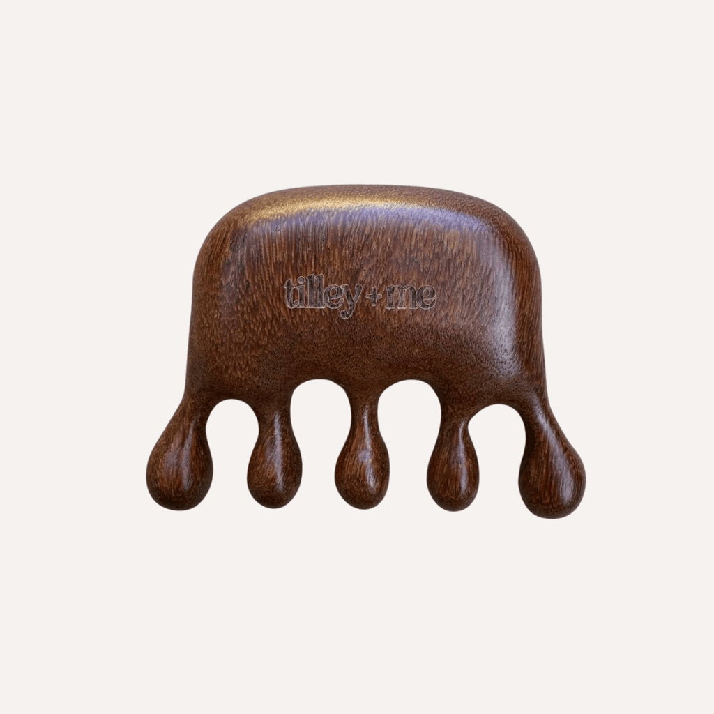 Wooden hand massager with 'tilly & tina' branding on a white background