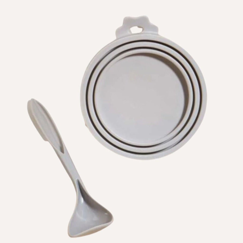 Set of white bowls and a spoon on a white background