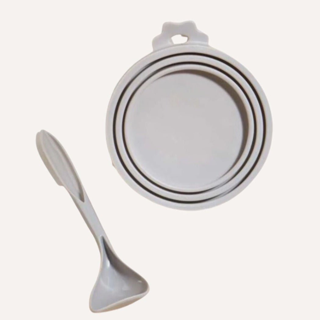 Set of white bowls and a spoon on a white background