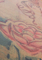 Close-up of a tattoo on skin with intricate designs.
